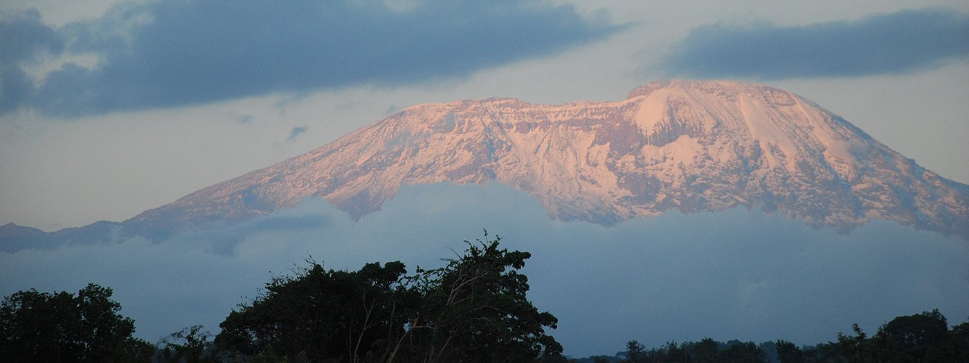 Trekkers ascending Mount Kilimanjaro above the clouds